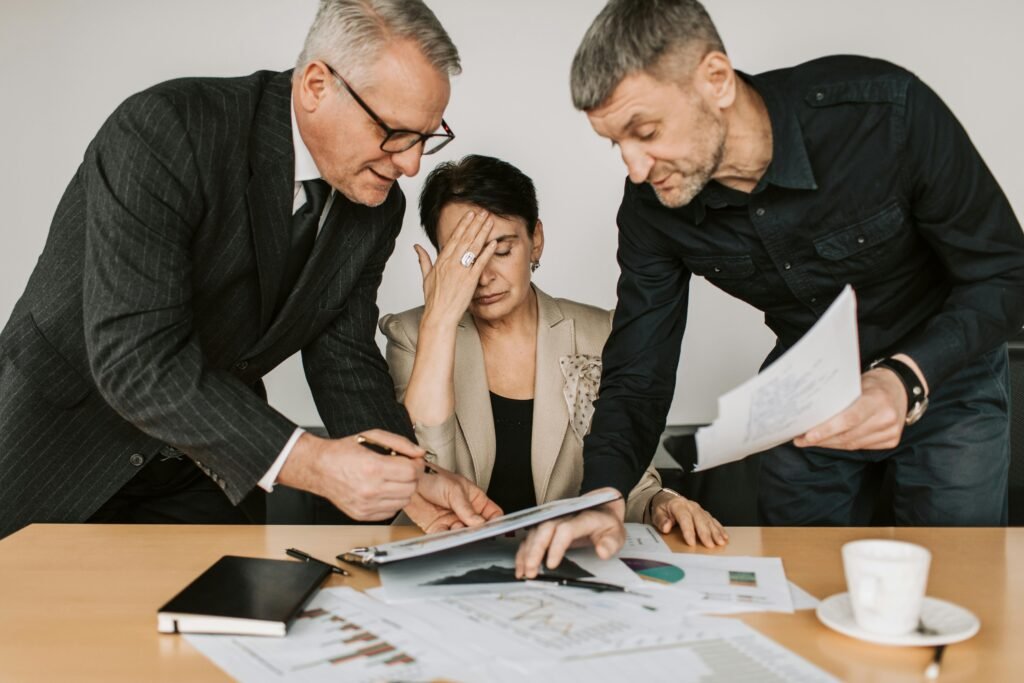 pexels-photo-7433871-7433871 A professional team in a tense business meeting discussing financial documents.