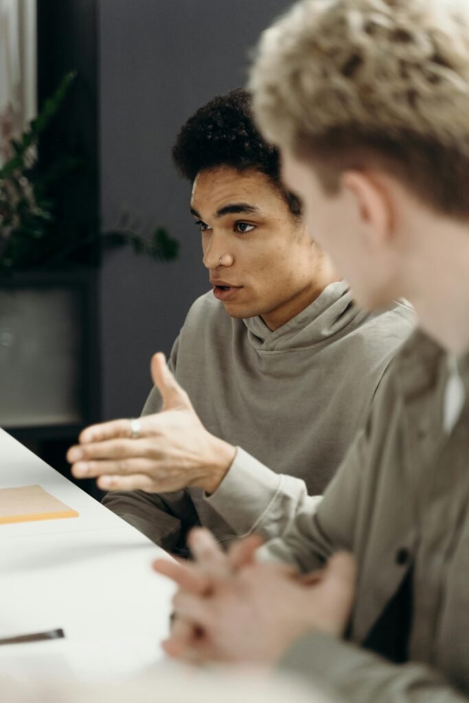 pexels-photo-7430333-7430333 Two professionals engaged in discussion in a modern office setting, emphasizing teamwork and collaboration.