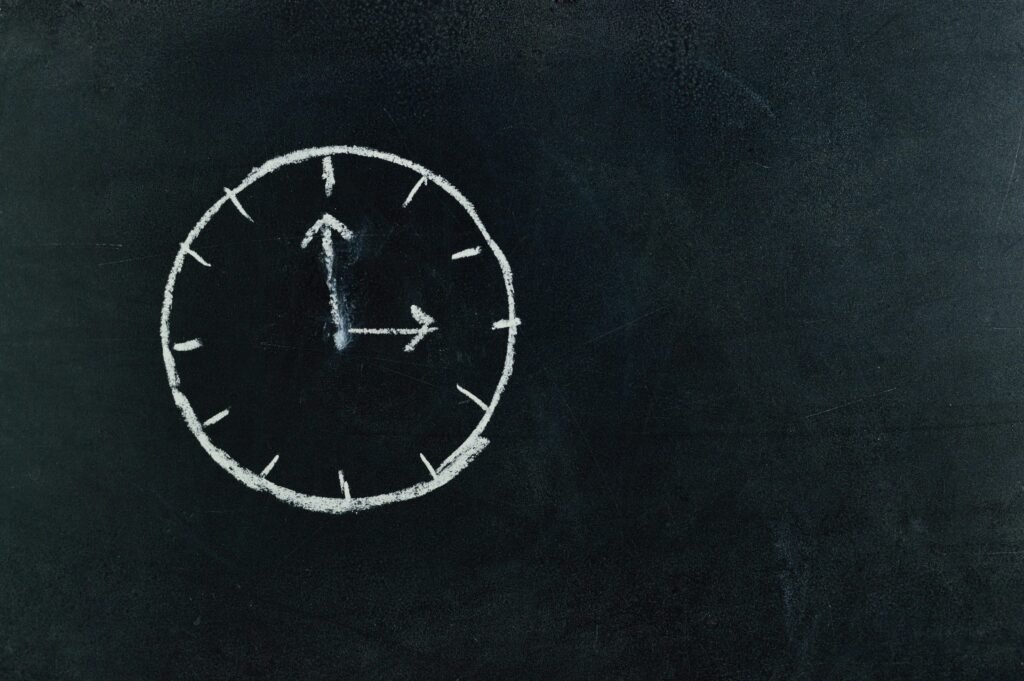 pexels-photo-745365-745365 Chalk-drawn clock on a blackboard, symbolizing time and education concepts.