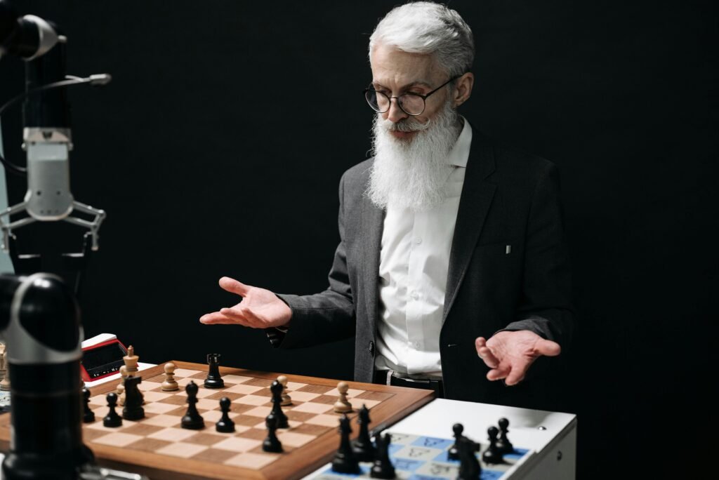 pexels-photo-8438930-8438930 A senior man plays chess against a robot, mixing tradition with modern technology.
