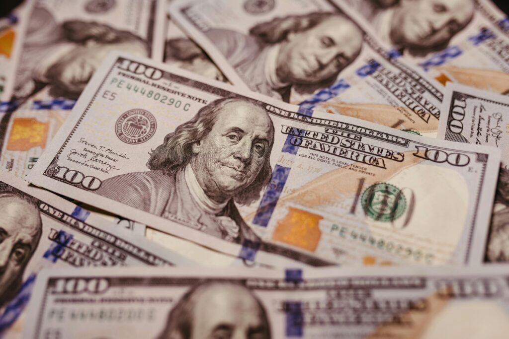 pexels-photo-14820471-14820471 Pile of 100 dollar bills depicting wealth and financial success in close-up view.