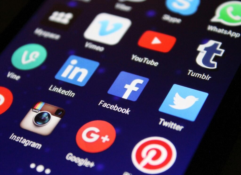 pexels-photo-267350-267350 Close-up of a smartphone screen showing various social media app icons such as Facebook and Twitter.