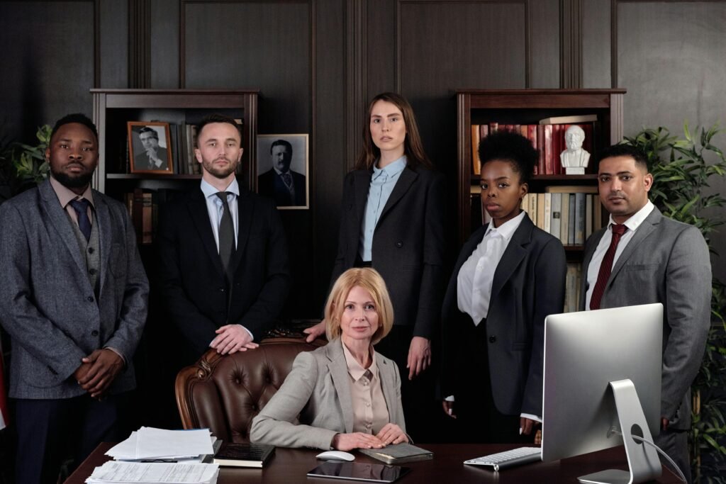 pexels-photo-4427430-4427430 Diverse group of professionals in corporate attire posing confidently in an office environment.