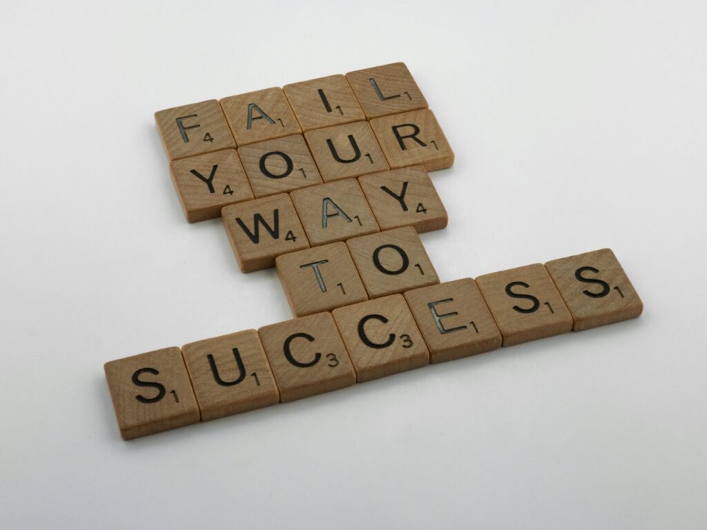 pexels-photo-5978426-5978426 Wooden tiles spell 'Fail Your Way to Success' emphasizing perseverance.